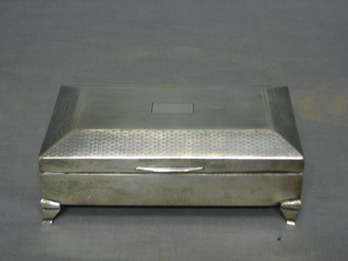 An Art Deco silver cigarette box with engine turned decoration, raised on bracket feet, Birmingham 1931 6"