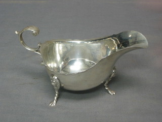 An Edwardian silver sauce boat with wavy cut border, raised on 3 hoof feet, Chester 1910, 4 ozs