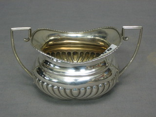 An oval silver twin handled sugar bowl with demi-reeded decoration Birmingham 1886 4 ozs