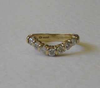 A lady's 18ct gold wish bone shaped dress ring set 7 diamonds