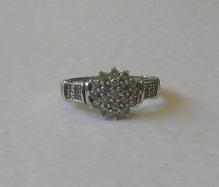 A lady's 9ct white gold cluster dress ring set illusion cut diamonds