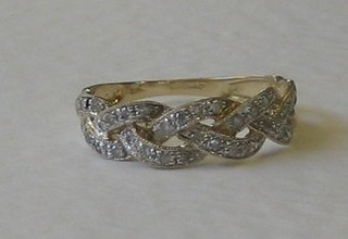 A lady's 18ct gold dress ring in the form of a chained garland set numerous diamonds