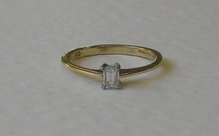 A lady's 18ct gold dress ring set a baguette cut diamond