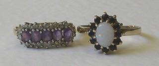 A lady's 9ct gold dress ring set an oval coloured stone supported by a red stone and an amethyst and white stone set ring