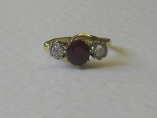 A yellow gold dress ring set a ruby and 2 diamonds