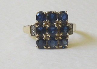 A 9ct gold dress ring set sapphires supported by diamonds