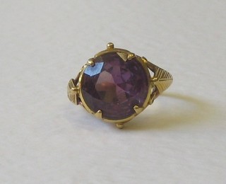 A gold dress ring set an amethyst coloured stone