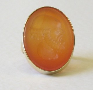 A gold dress ring set a "Cornelian" intaglio cut seal in the form of a gentleman's head