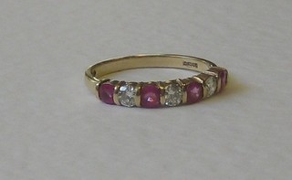 A gold half eternity ring set 3 diamonds supported by 4 rubies