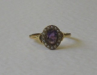 A gold dress ring set an amethyst surrounded by demi-pearls