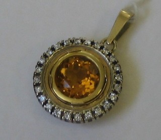 An 18ct gold pendant set a circular cut citrene surrounded by diamonds