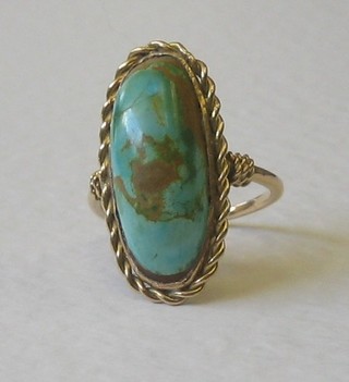 A 9ct gold dress ring set an oval cabouchon cut turquoise