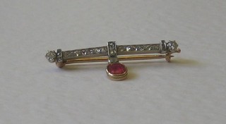 A 9ct gold bar brooch set numerous diamonds hung an oval cut ruby
