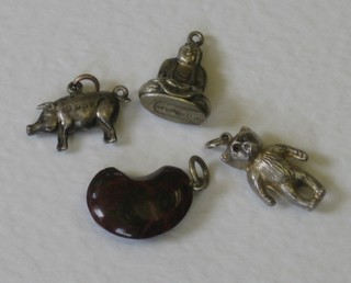 A "silver" charm in the form of a pig, do. Buddha, teddybear and a hardstone in the form of a bean