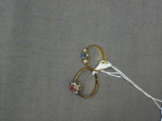 A gold dress ring set an oval cut aquamarine supported by 2 pearls and a gilt metal dress ring set a pink and white stone