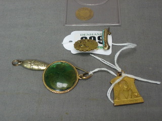 A gilt metal pendant decorated Lourdes, a gilt metal locket decorated a leaf, a metal bookmark and 2 gilt metal brooches
