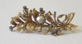 A gold floral shaped spray brooch set pearls, green and white stones