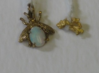 A gold insect brooch set an opal and a small gold nugget