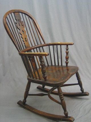 A 19th Century elm and ash stick back rocking chair with solid elm seat and cow horn stretcher