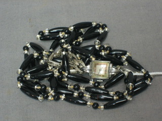 A string of silver Art Deco beads and a cocktail wristwatch