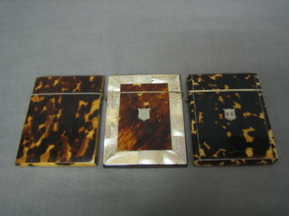 A 19th Century tortoiseshell card case with hinged lid and silver shield decoration to the front, another with mother of pearl banding and 1 other (3)