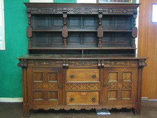 A Continental hardwood dresser, the raised back with moulded cornice fitted 2 shelves, the base fitted 3 long drawers flanked by cupboards 78" 