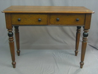 A Victorian oak side table fitted 2 drawers, raised on turned and chamfered supports 46"