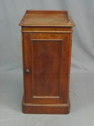 A Victorian mahogany pedestal pot cupboard with three-quarter gallery enclosed by a panelled door, raised on a platform base 16"