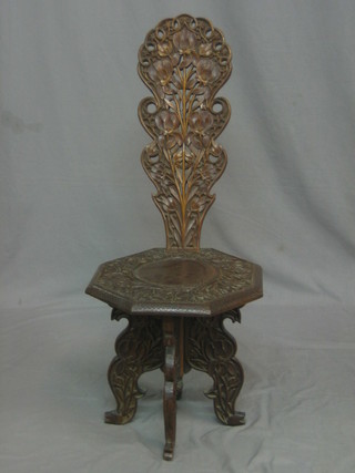 An Eastern carved hardwood spinning chair with pierced splat back and octagonal seat, raised on cabriole supports