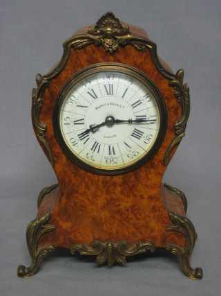 A 1920's Louis VX style clock contained in a shaped walnut frame with gilt metal mounts, having an enamelled dial with Roman numerals, by Mappin & Webb