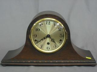 A 1930's 8 day striking mantel clock with silvered dial and Arabic numerals contained in an oak Admiral's hat shaped case
