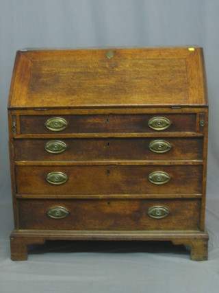 A Georgian oak bureau with fall front, revealing a well fitted interior above 4 long drawers, raised on bracket feet 36"