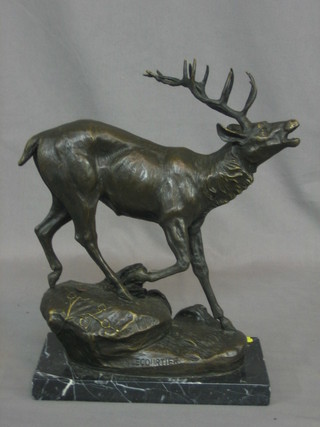 A modern reproduction bronze figure of a standing stag, raised on a marble base 12"