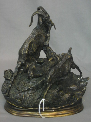 A modern reproduction bronze figure of 2 goats, raised on a rock outcrop base 11"