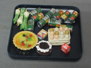 A dolls house tray of eggs, a cake, a flan, 3 leeks, an oxo cube, a packet of Bisto and 10 tins of tinned fruit