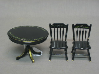 A dolls house Victorian style circular black lacquered pedestal dining table 3" together with a pair of bar back dining chairs