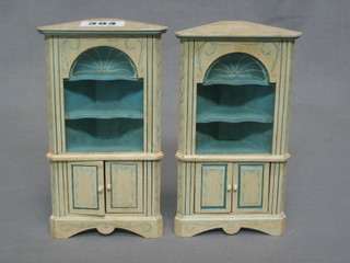 A dolls house pair of  Adam style white painted double corner cabinets, raised on bracket feet 3 1/2"