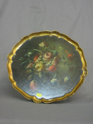 A circular lacquered tea tray with floral decoration and bracketed border 15"