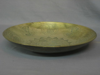 A large circular Eastern engraved brass bowl decorated a dragon 16"
