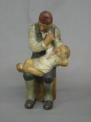 A Continental carved wooden figure of a seated Father and Baby 9"