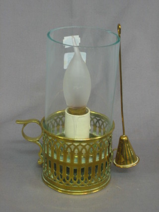 A reproduction brass chamber stick with storm glass converted to an electric table lamp