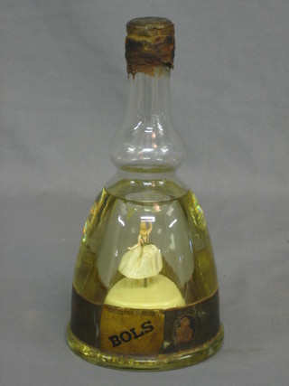 A bottle of Bols liqueur with musical box movement to the base
