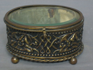 A Continental music box contained in an oval embossed metal casket with hinged lid  5"