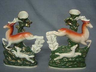 A pair of 19th Century Staffordshire spill vases in the form running deer with hounds 11" (1 f and heavily crazed)