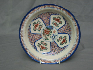 A 17th/18th Century circular Delft dish with panelled and floral decoration marked Gie 170 9/10 9 1/2" (cracked)