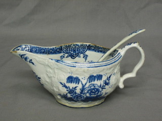 An  18th/19th Century blue and white sauce boat with transfer decoration together with a small blue and white ladle
