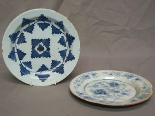 A 17th/18th Century circular Delft plate 8 1/2" (cracked), a circular Delft plate with floral decoration 8 1/2" (large chip)