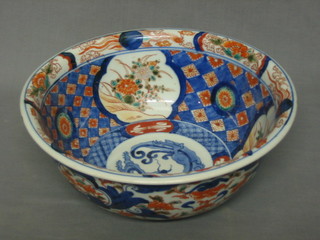 A 19th Century circular Japanese Imari porcelain bowl decorated a dragon and with panel decoration, the base with 4 character mark 11"