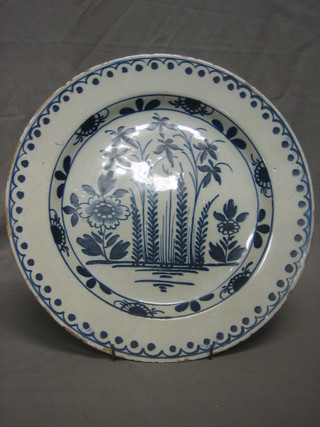A Delft blue and white charger with floral decoration 14"