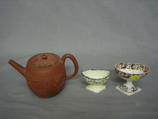 A faience style oval trencher salt on a diamond shaped base 3 1/2" (chips to base), a brown glazed do. (chip to interior) and a circular Tanware teapot 3" (chip to lid)